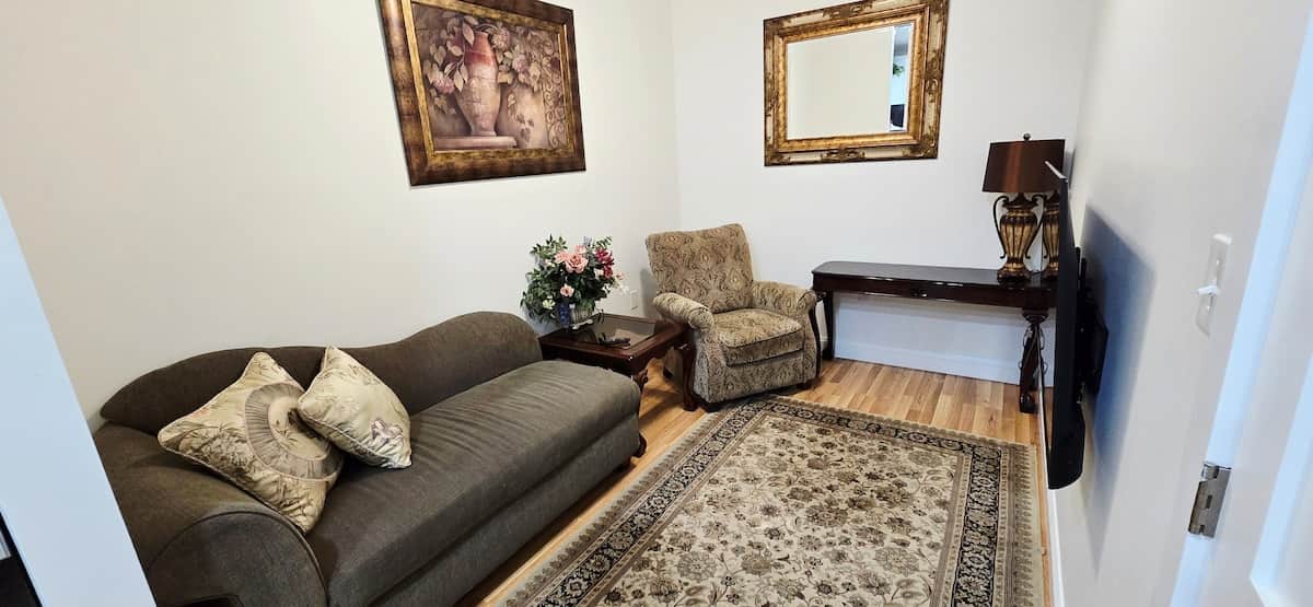 The Lorraine Living Room is a cozy space where you can relax and feel at home. It features a smart TV, a comfy recliner and chaise lounge that’s great for lounging, reading, or taking a nap. It’s a comfortable spot to unwind after a busy day.