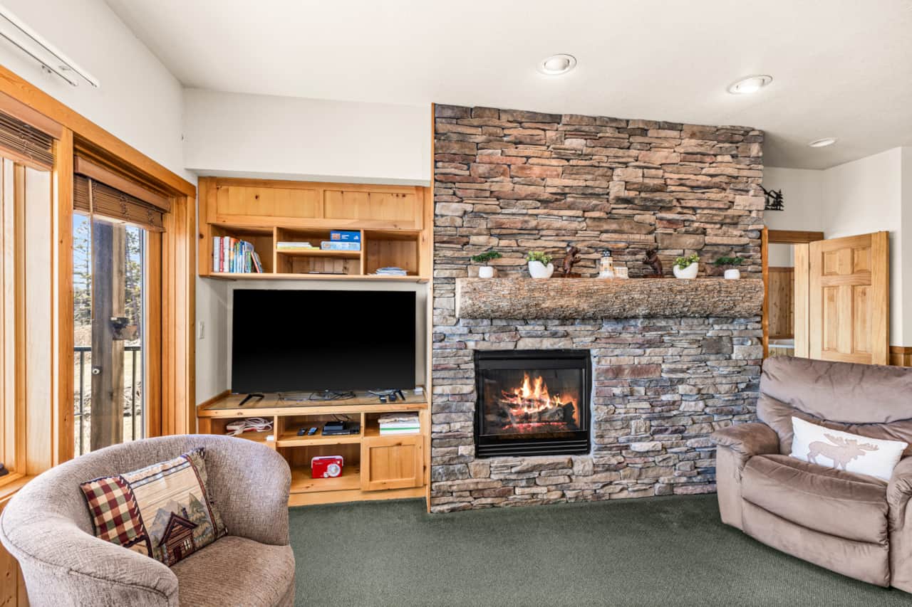 Warm fireplace, comfy sofa, perfect living room vibes.