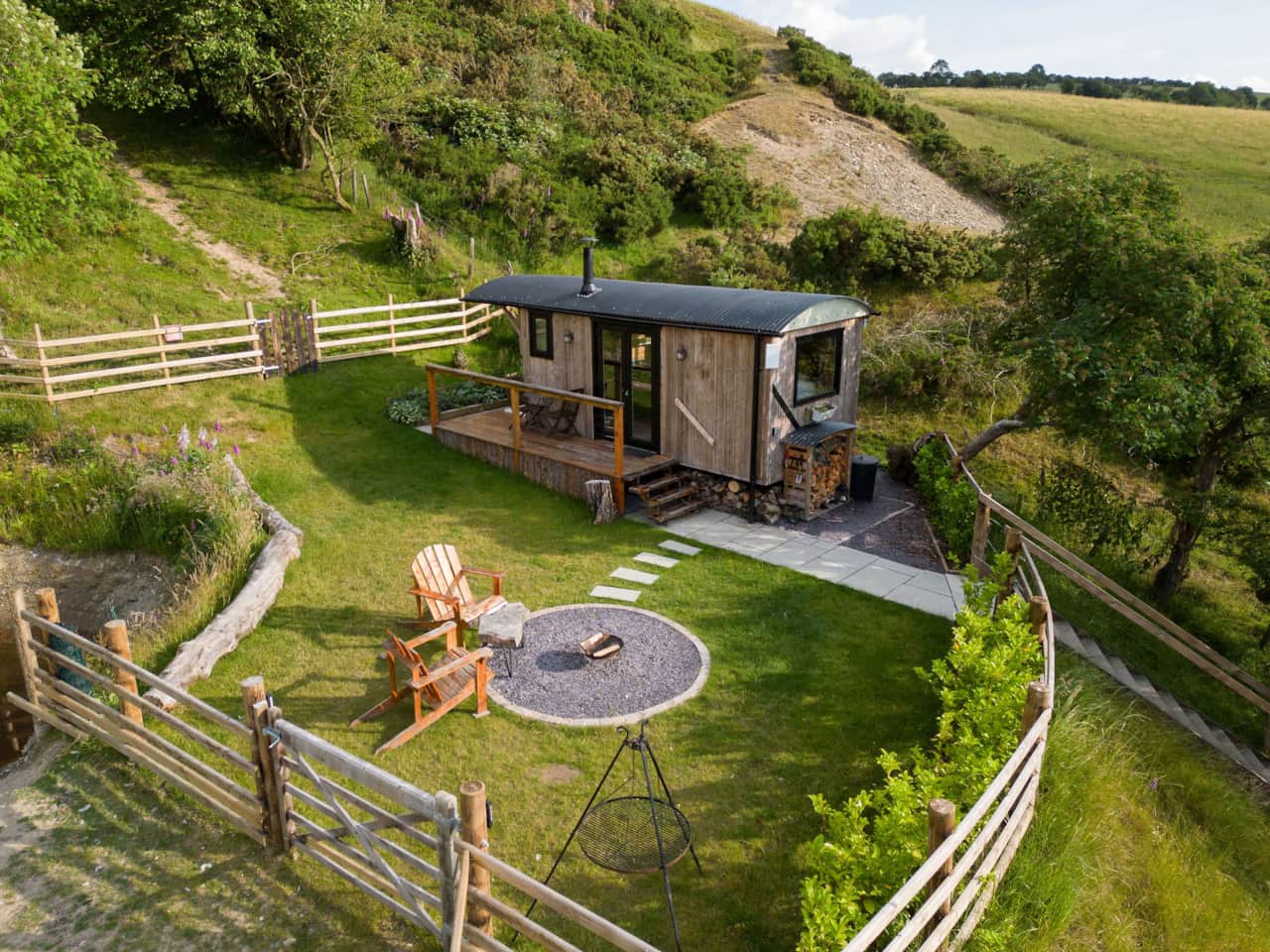 Aerial view of secluded shepherd's hut surrounded by nature.
