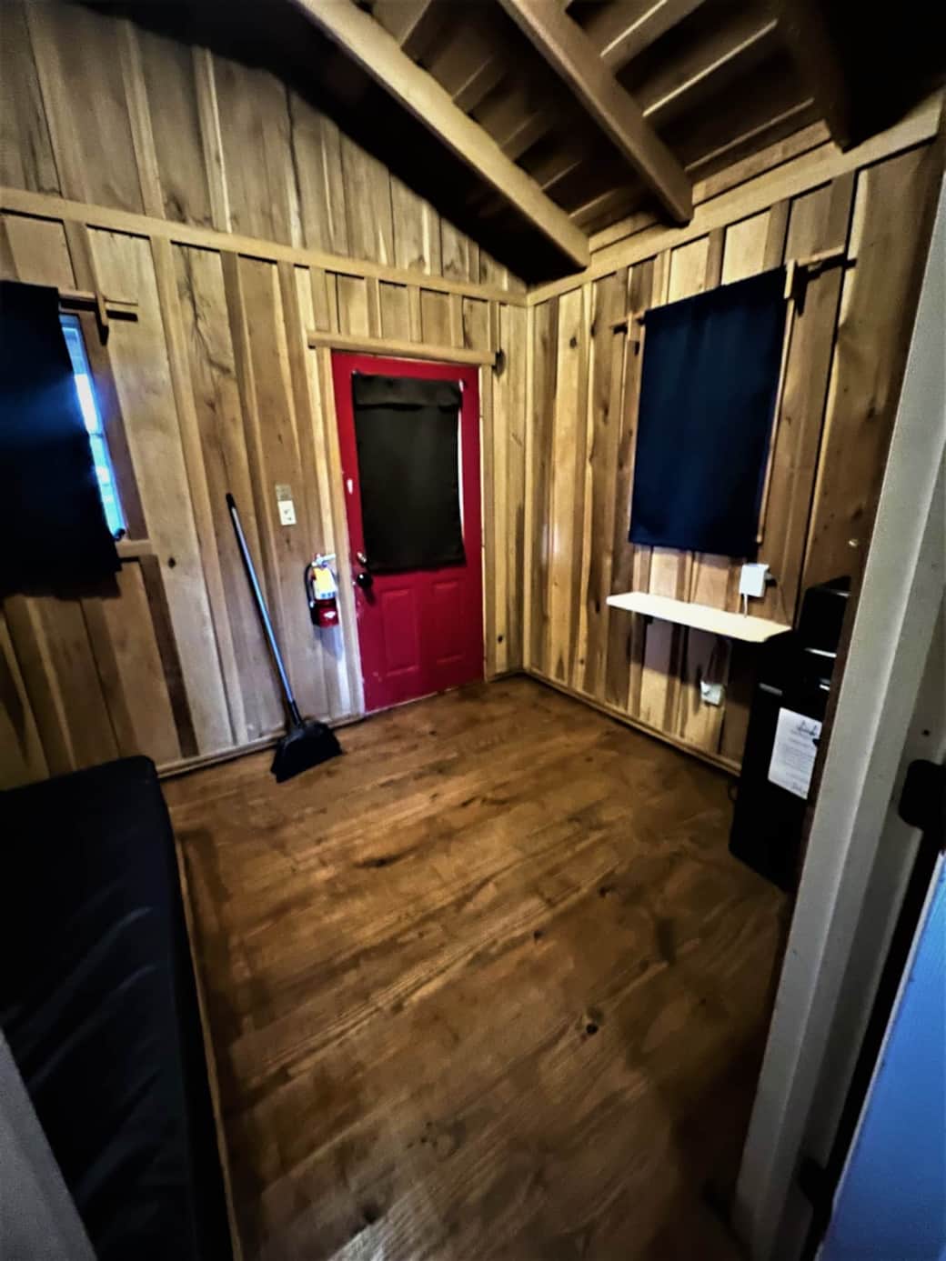 Front bedroom with full size bed, microwave and dorm fridge