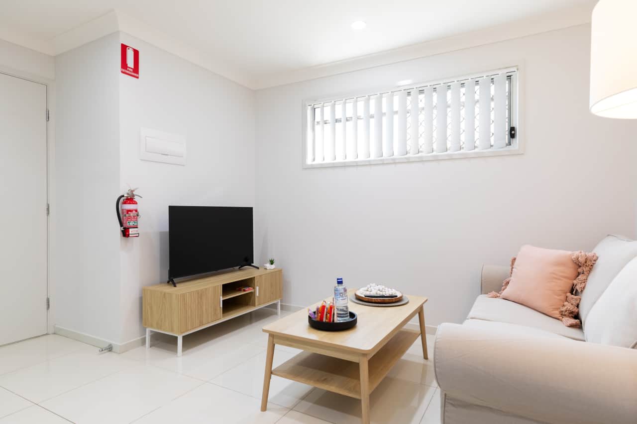 Living Area: Bright living space with comfortable seating and TV 