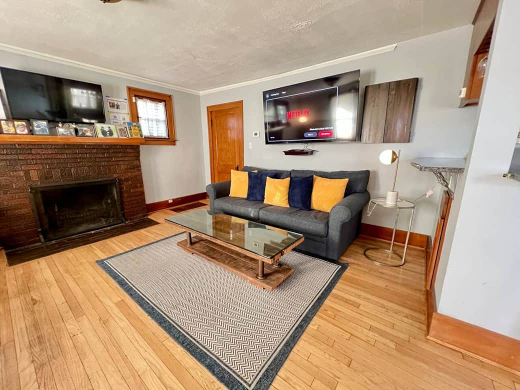 Living room features two flat screen TVs Living room features two flat screen TVs