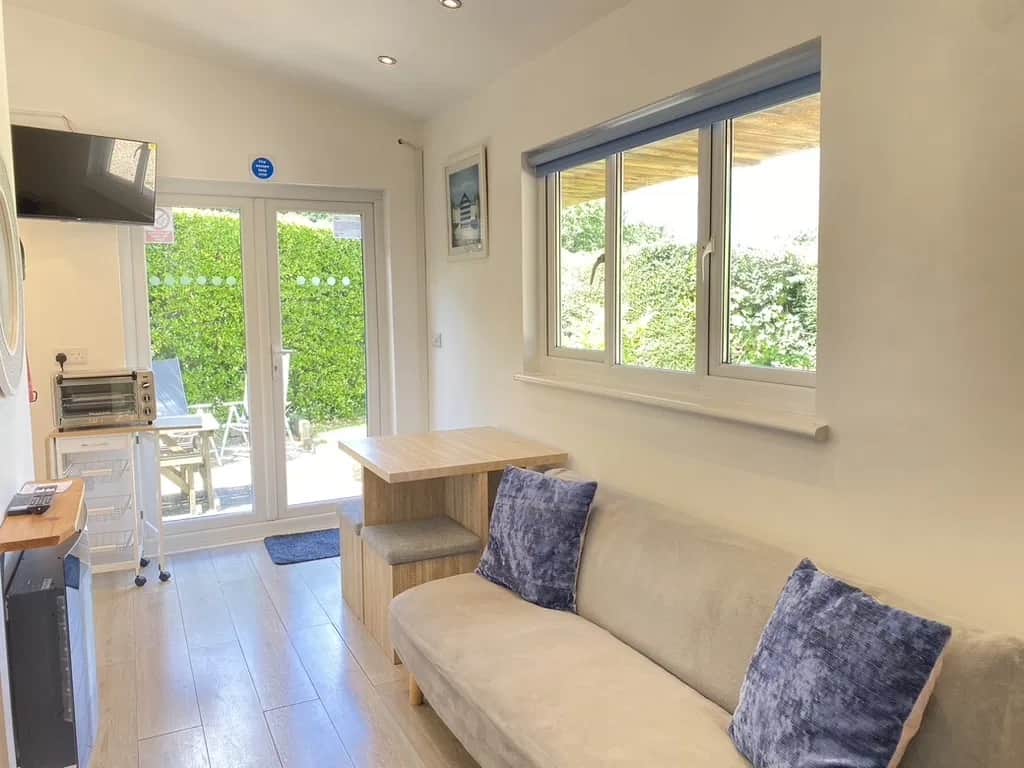 Bright, open living space with the garden just beyond the doors Bright, open living space with the garden just beyond the doors