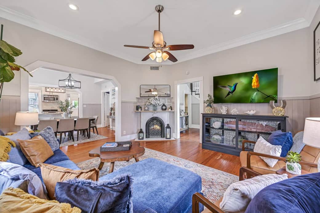 View of spacious main living room, fireplace, luxurious, comfortable seating for all guests. Amazing original windows w/blackout curtains surround.
Original hardwoods and open concept continue to large dining room and kitchen. View of spacious main living room, fireplace, luxurious, comfortable seating for all guests. Amazing original windows w/blackout curtains surround.
Original hardwoods and open concept continue to large dining room and kitchen.