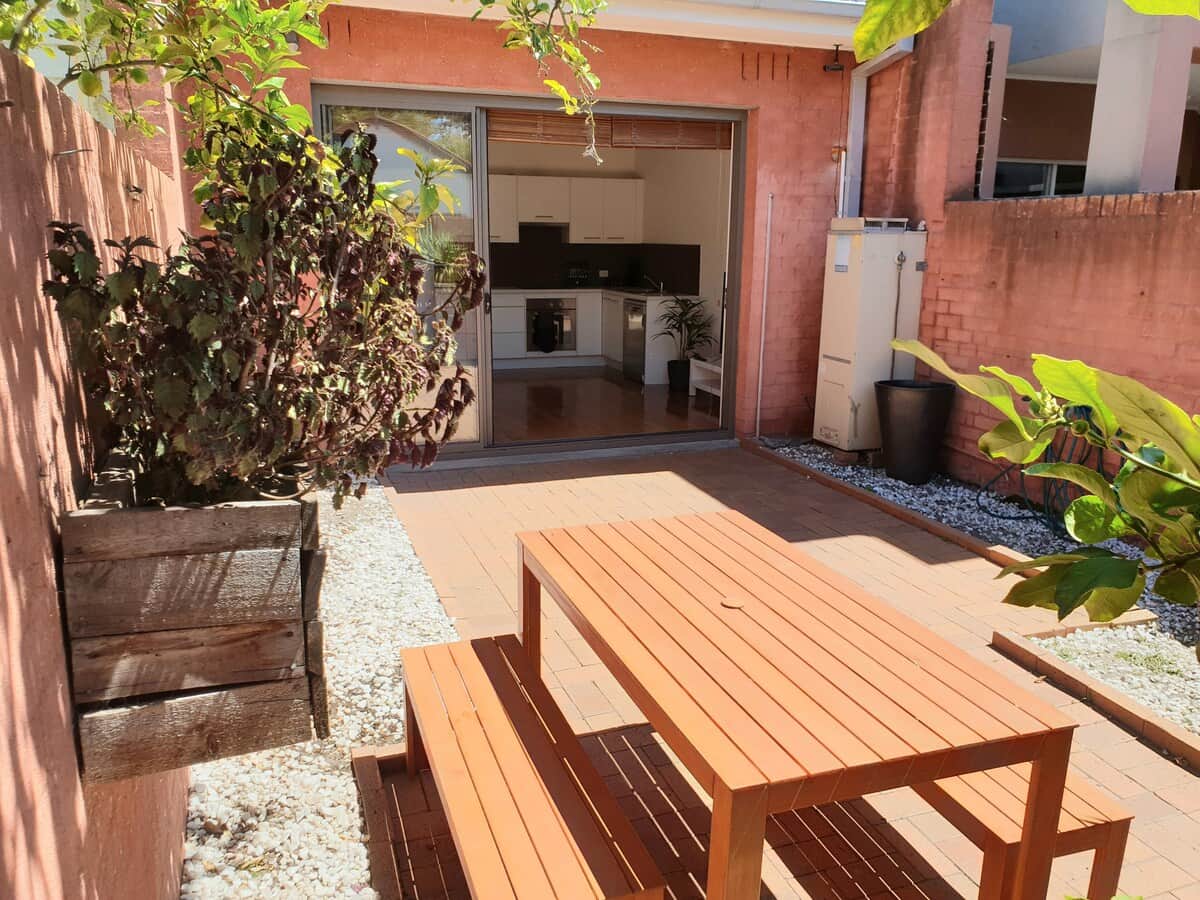 Courtyard looking into the kitchen and lounge area. Outdoor table to allow more space inside.