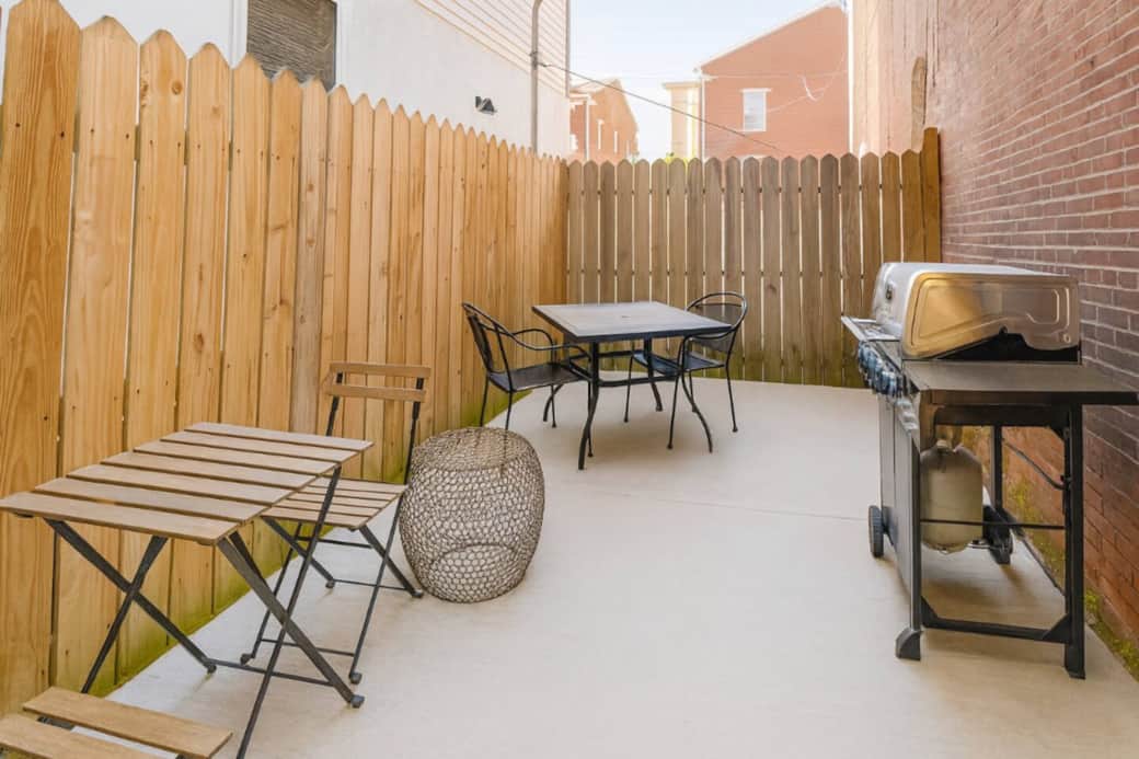 Very large Private backyard with barbecue grill and outdoor dining set.
