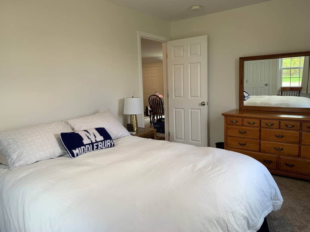 Bedroom 2 has a comfy queen, bedside tables, a large dresser, and two closets