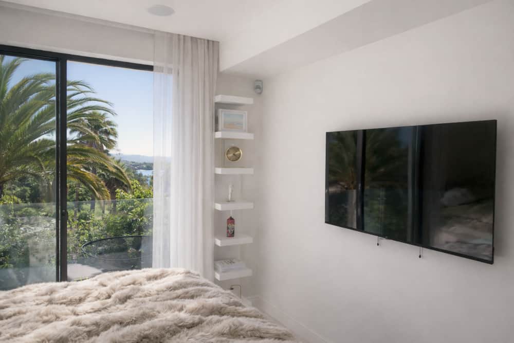 Bedroom of Villa Luz Bliss with a sea view through the palms