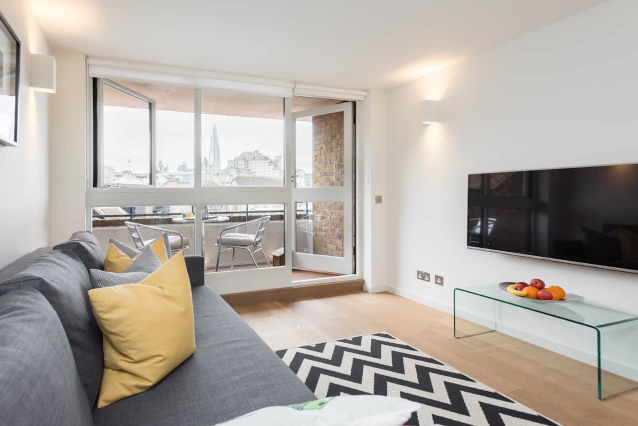Wall-mounted TV and glimpses of the London skyline through the balcony doors