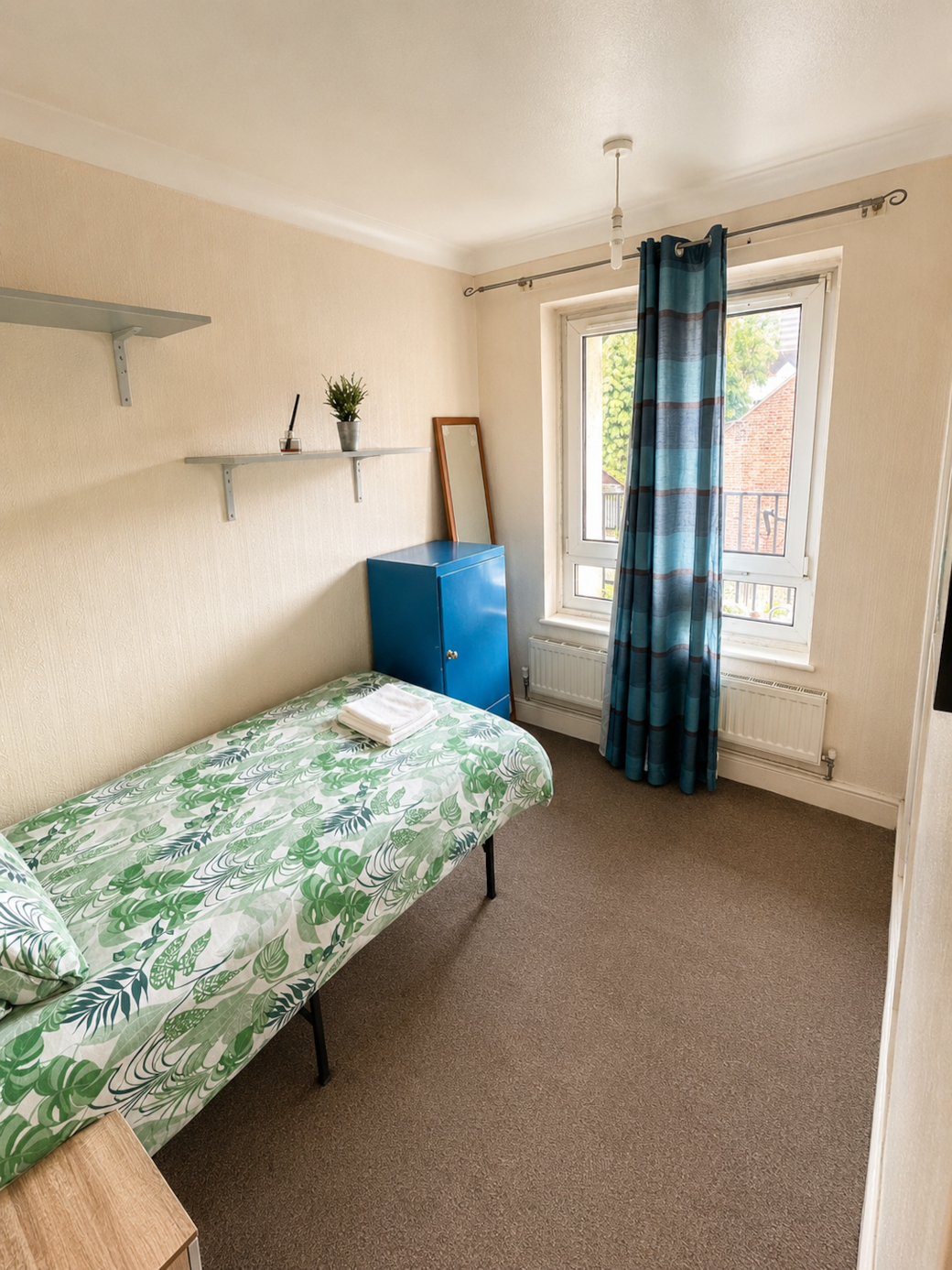Simple and practical single bedroom with wardrobe space