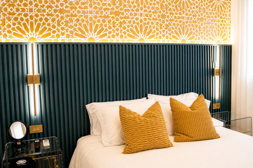 Luxurious bedroom with Queen bed, ambient lighting, and bold modern design.