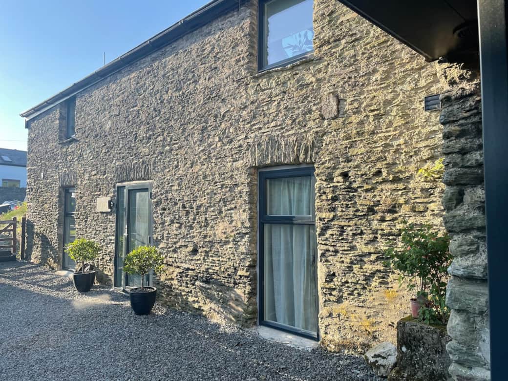 The exterior of The Byre, illustrating the two downstairs double bedrooms that provide comfortable sleeping accommodation.