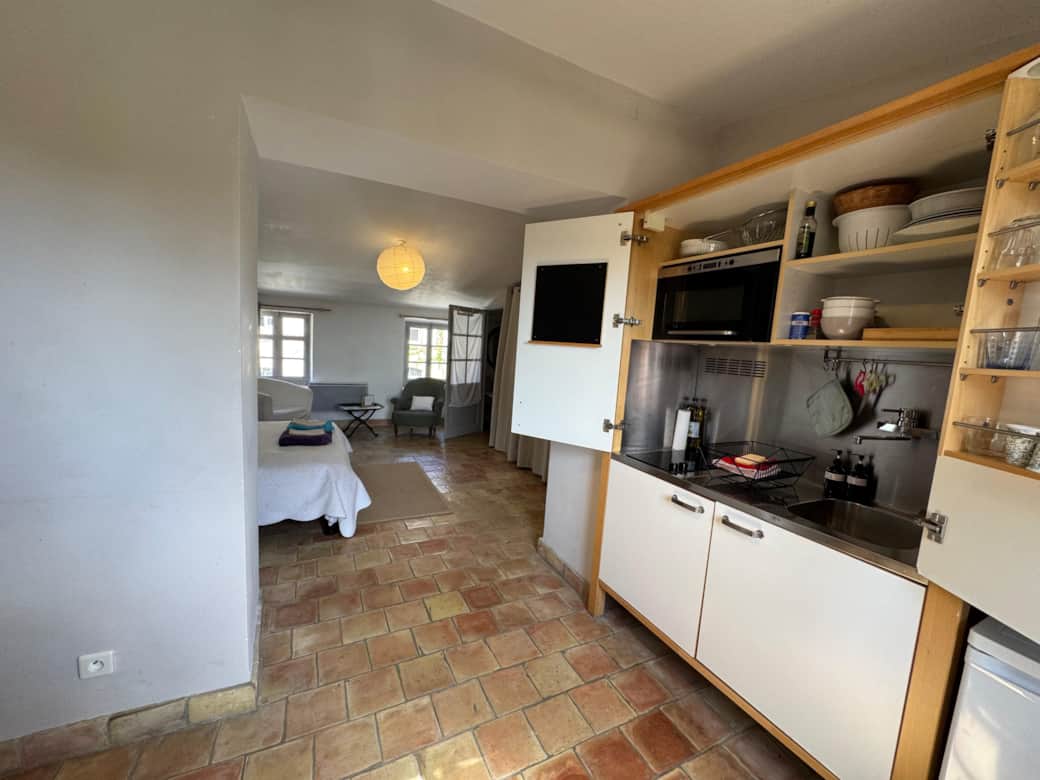 living room, fan, TV, bed area, towels, double bed, bathroom, kitchen, microwave