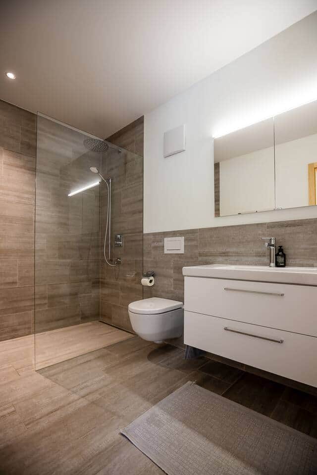 Bright, modern bathroom with a high-end rain shower and premium fittings.
