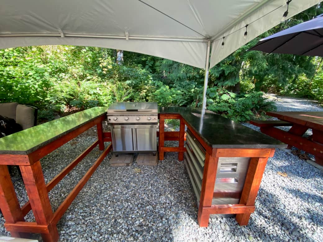 Outdoor kitchen with griddle style grill and prep area.