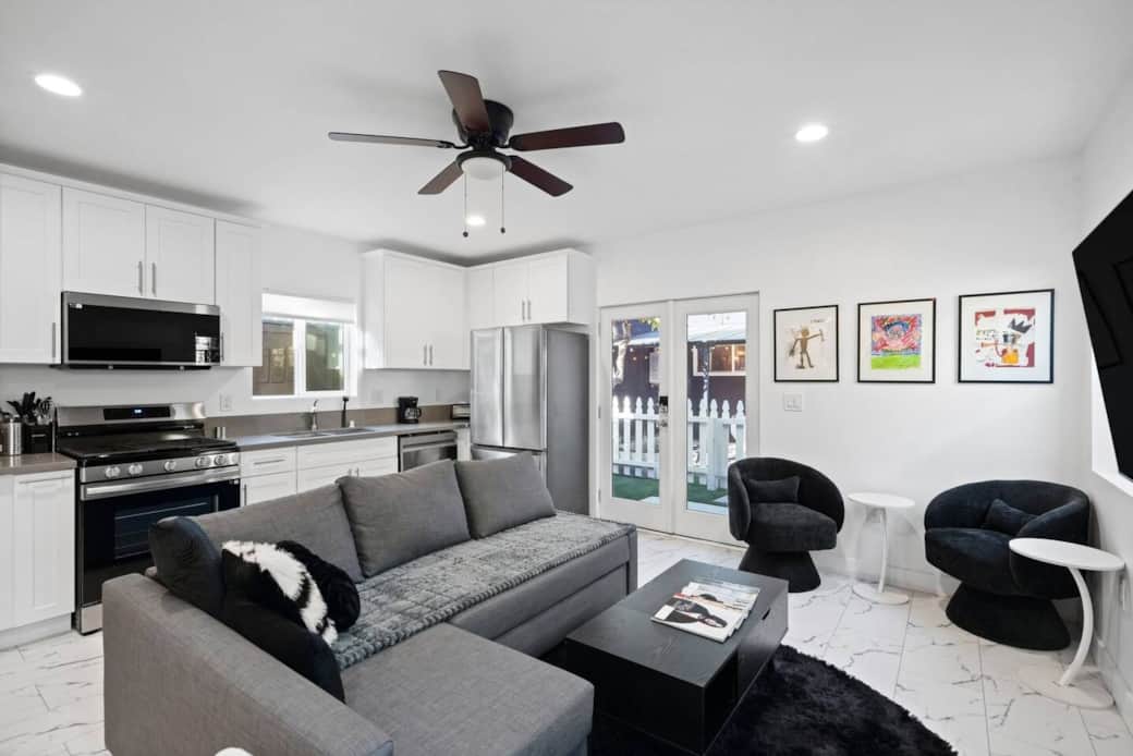 Open living area next to the kitchen with extra lounge seating, and French doors to the yard. Open living area next to the kitchen with extra lounge seating, and French doors to the yard.
