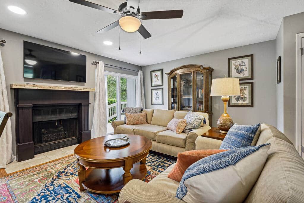 There is a large smart tv above the mantle. The fireplace has electric logs and heat.