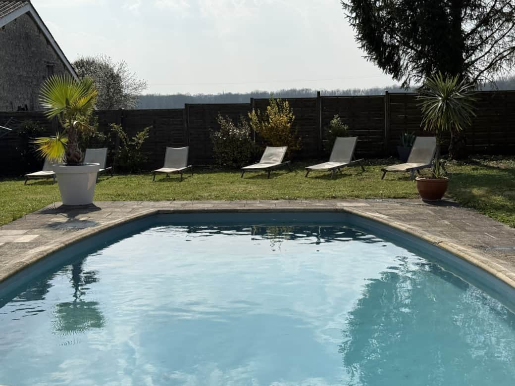 Private swimming pool with secure access and a pool house