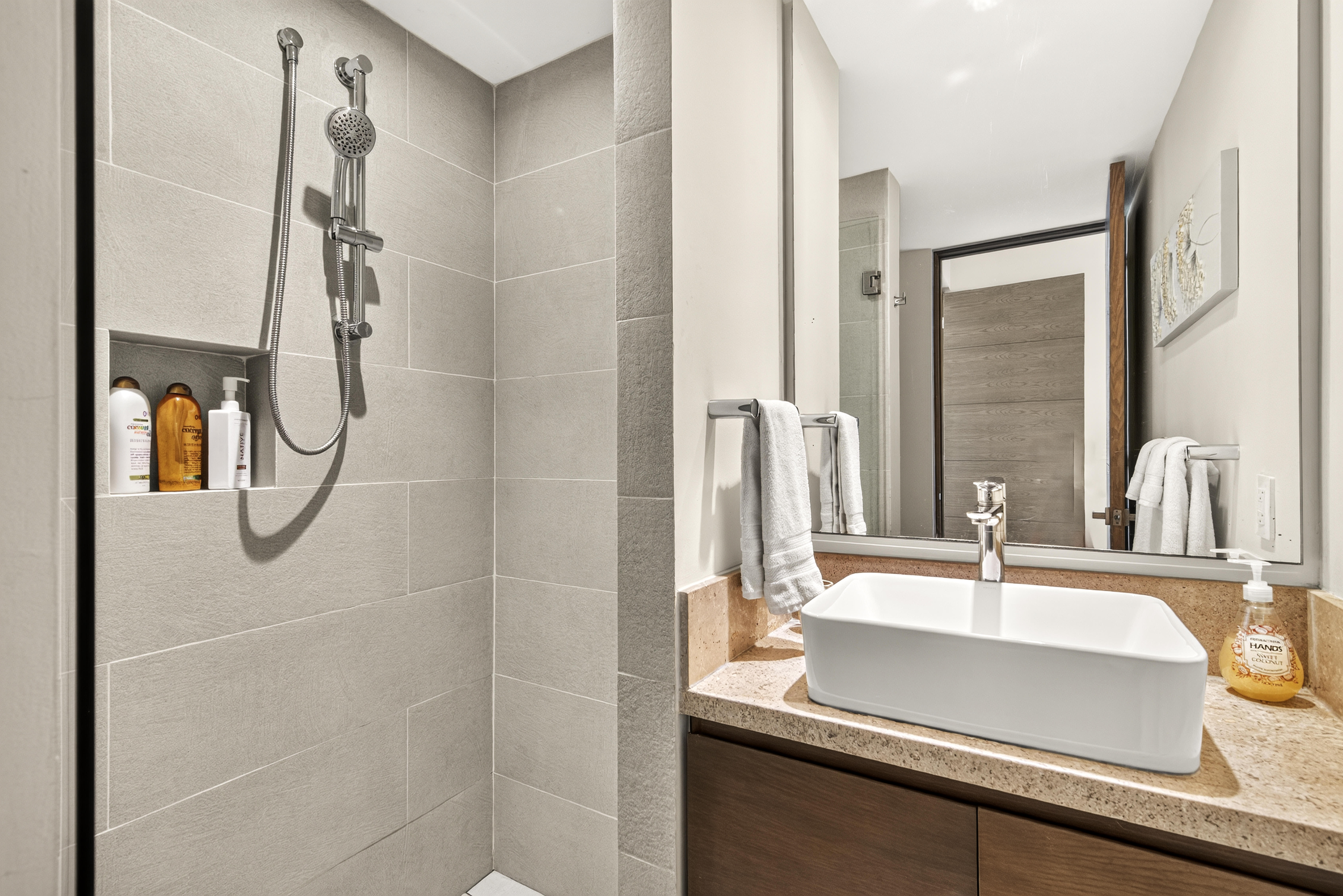 Ensuite bathroom with a walk-in shower and complimentary shampoo, conditioner, and body soap.