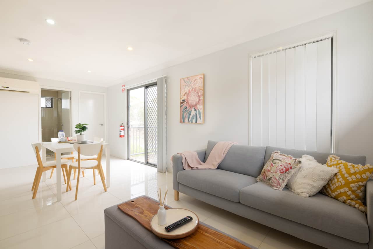 Living Area: Bright living space with comfortable seating and TV 