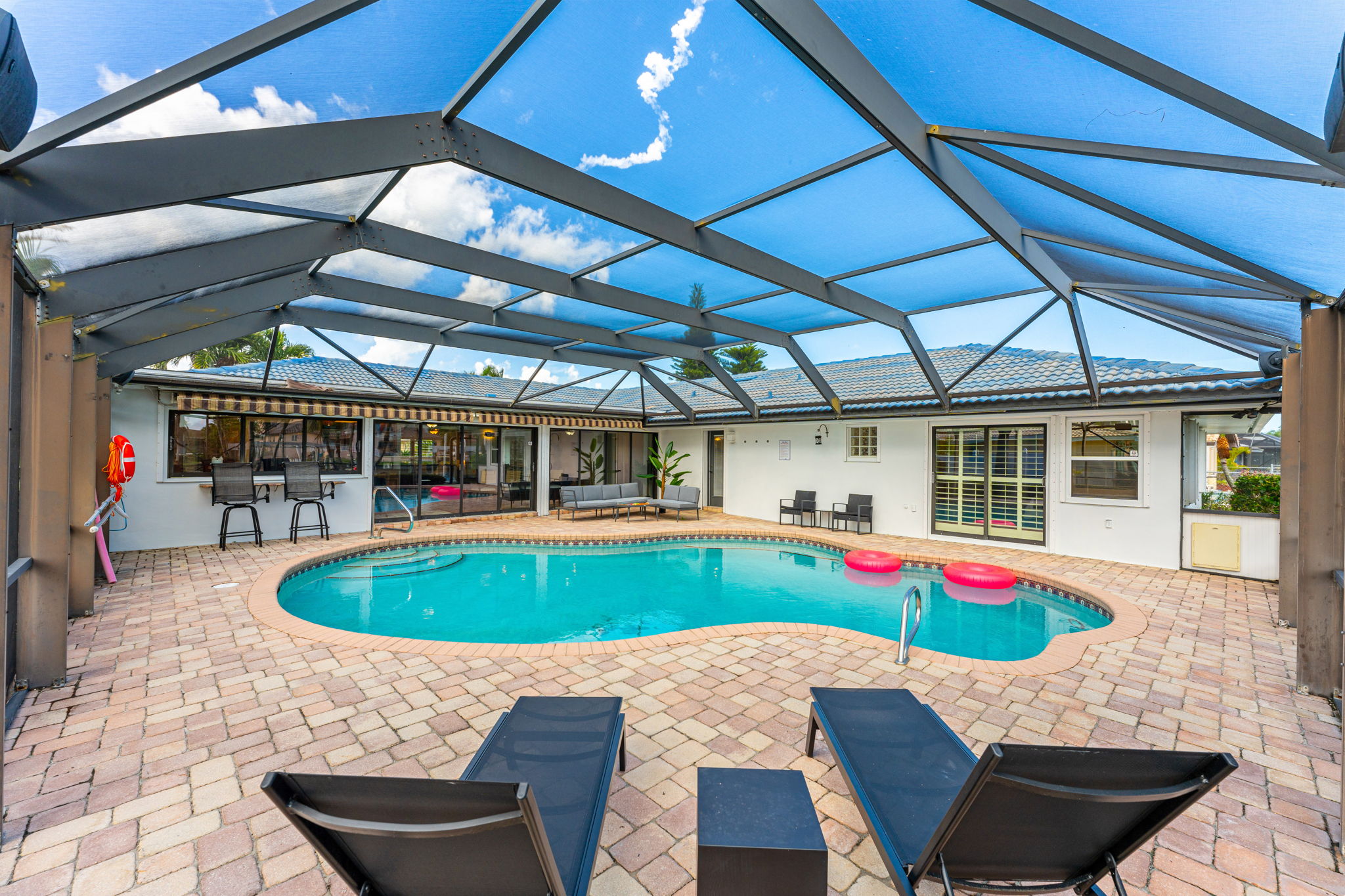 Relax in the private pool area with plenty of seating, perfect for sunbathing or cooling off.