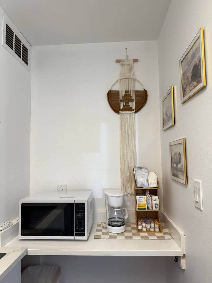 Coffee, tea, or microwave popcorn? This little nook has you covered. With a cozy setup, cute wall art, and all the fixings for your morning brew, it’s a tiny corner full of comfort.