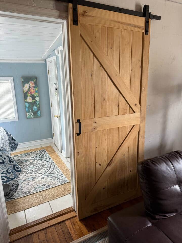 Private bedroom off living area with bath