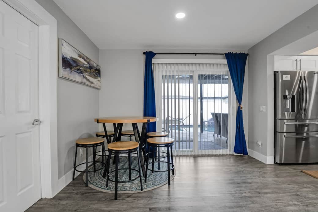 Cozy dining nook with seating for shared meals and family time. Located by sliding doors with natural light and easy access to the patio, creating a relaxed indoor-outdoor dining experience.
