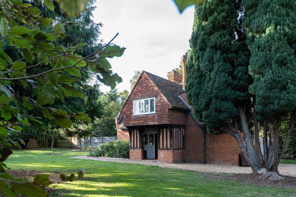 Front of cottage surrounded by its own private garden