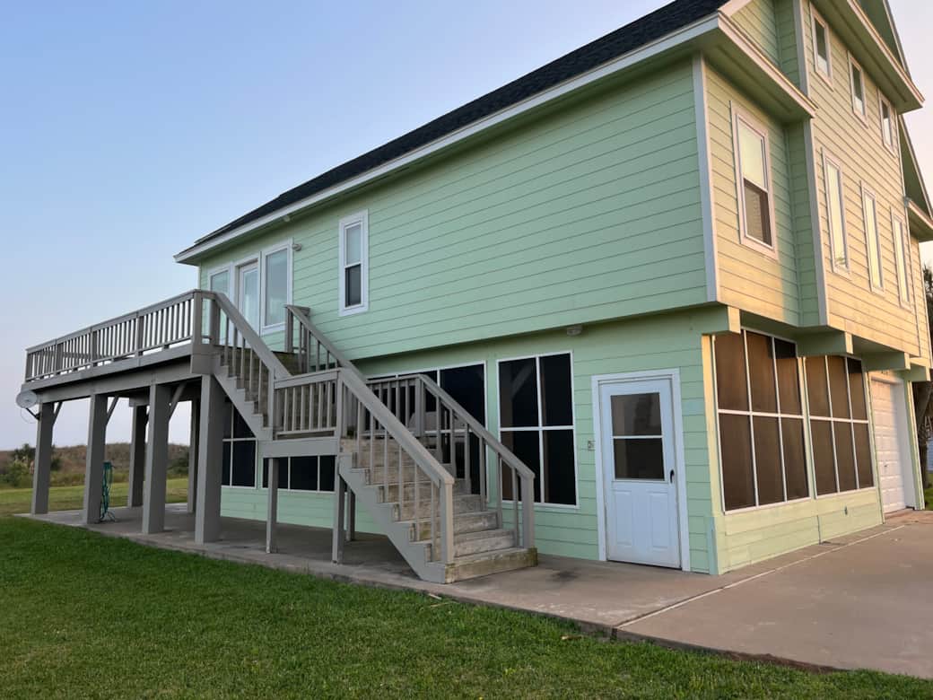 The home is accessed from the staircase. Below the home is a screened porch. The home is accessed from the staircase. Below the home is a screened porch.