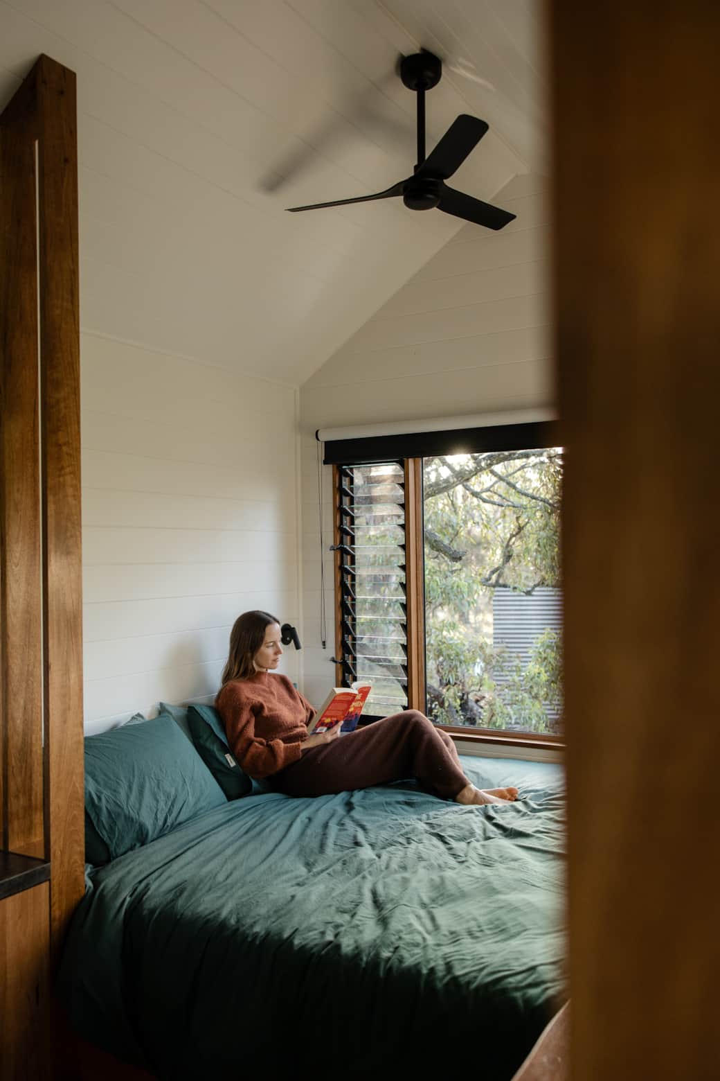 Unwinding on the king-sized bed with views through native garden to sauna