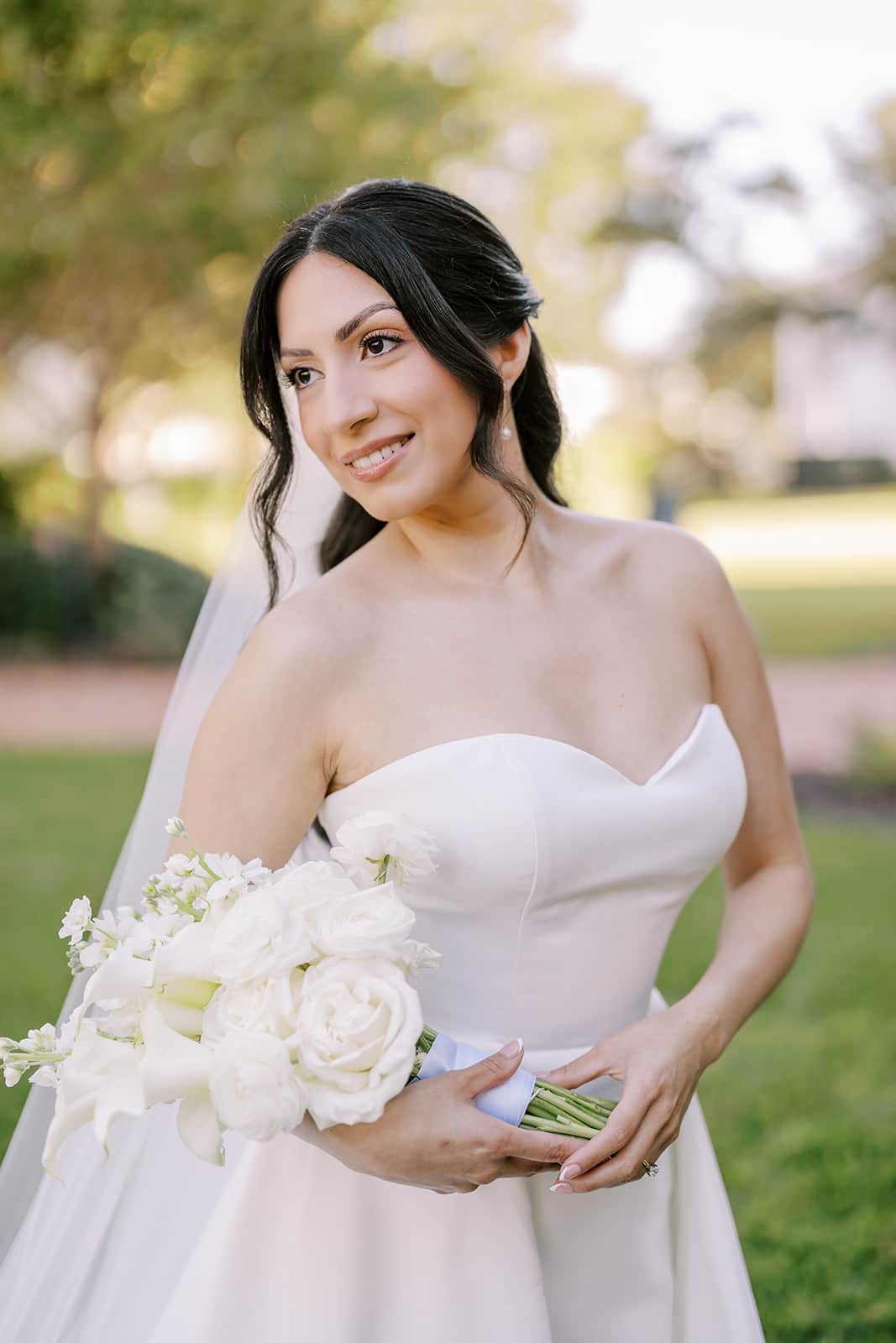 Bride portrait outside The Bryan Museum in Galveston holding a white wedding bouquet before the ceremony