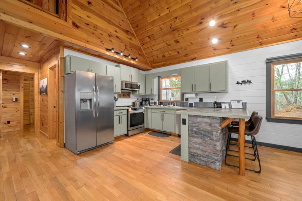 Our cabin kitchen features a full fridge-freezer, stocked spice rack, toaster, NutraBullet, slow cooker, induction stove with air fryer, blender, mixer, and all the utensils you need to cook a great meal.