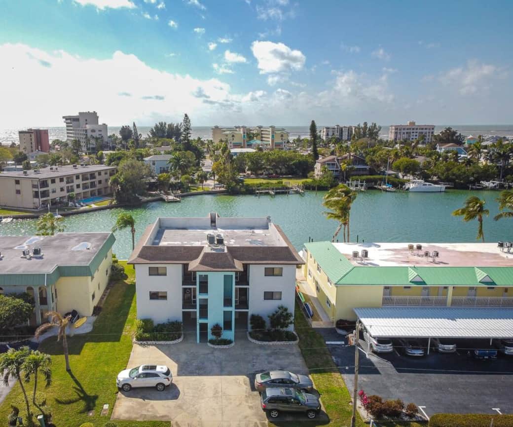 Welcome to Dolphin Drive. Peaceful condo with only 4 units with beautiful water views from the living room, primary bedroom and rear deck. 