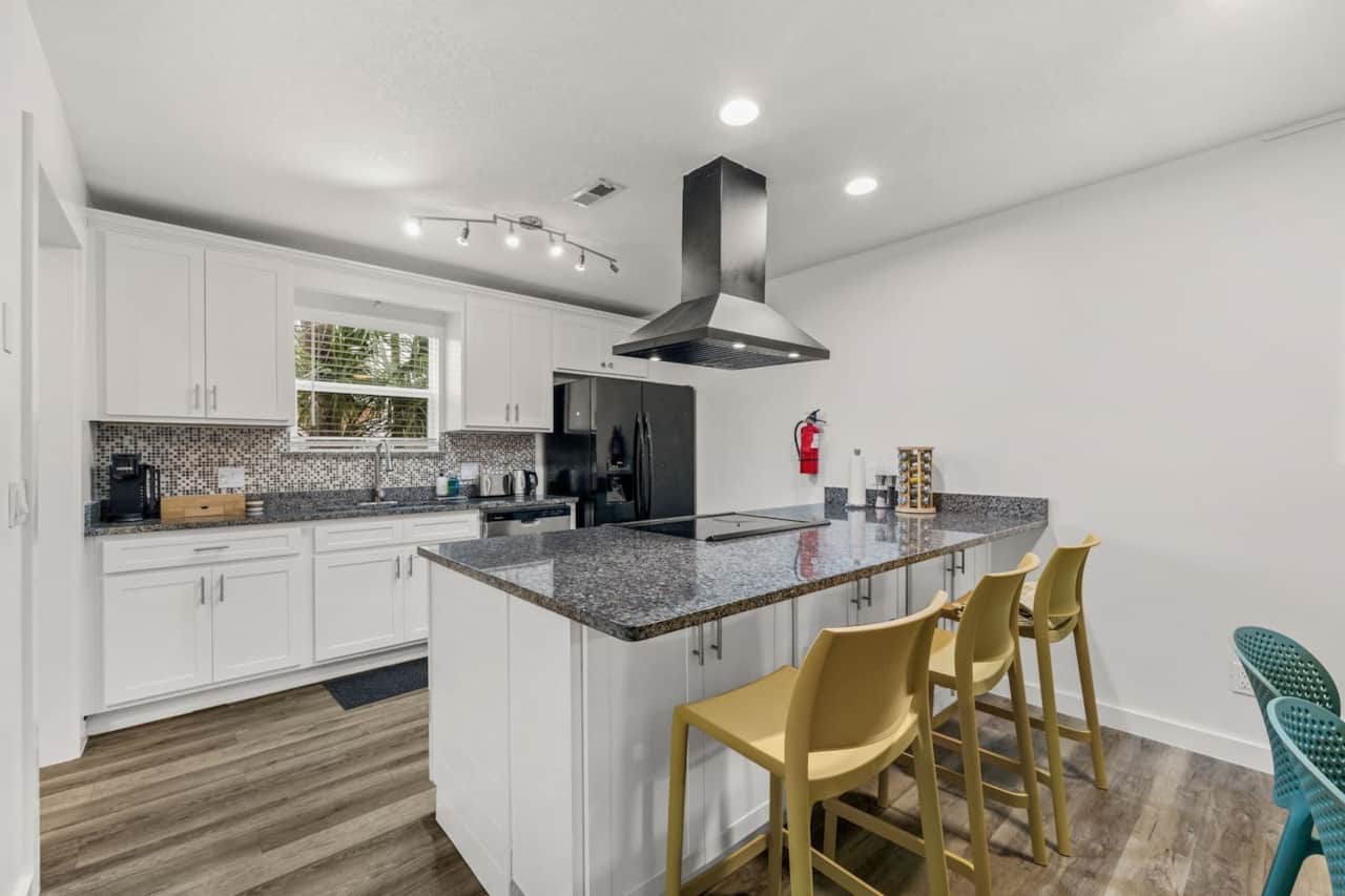 Cook comfortably in a stocked kitchen with a refrigerator, new Sharp microwave, dishwasher, and full stove and oven. The large island adds prep space and three bar seats. Cookware, bakeware, dinnerware, utensils, and wine glasses are provided