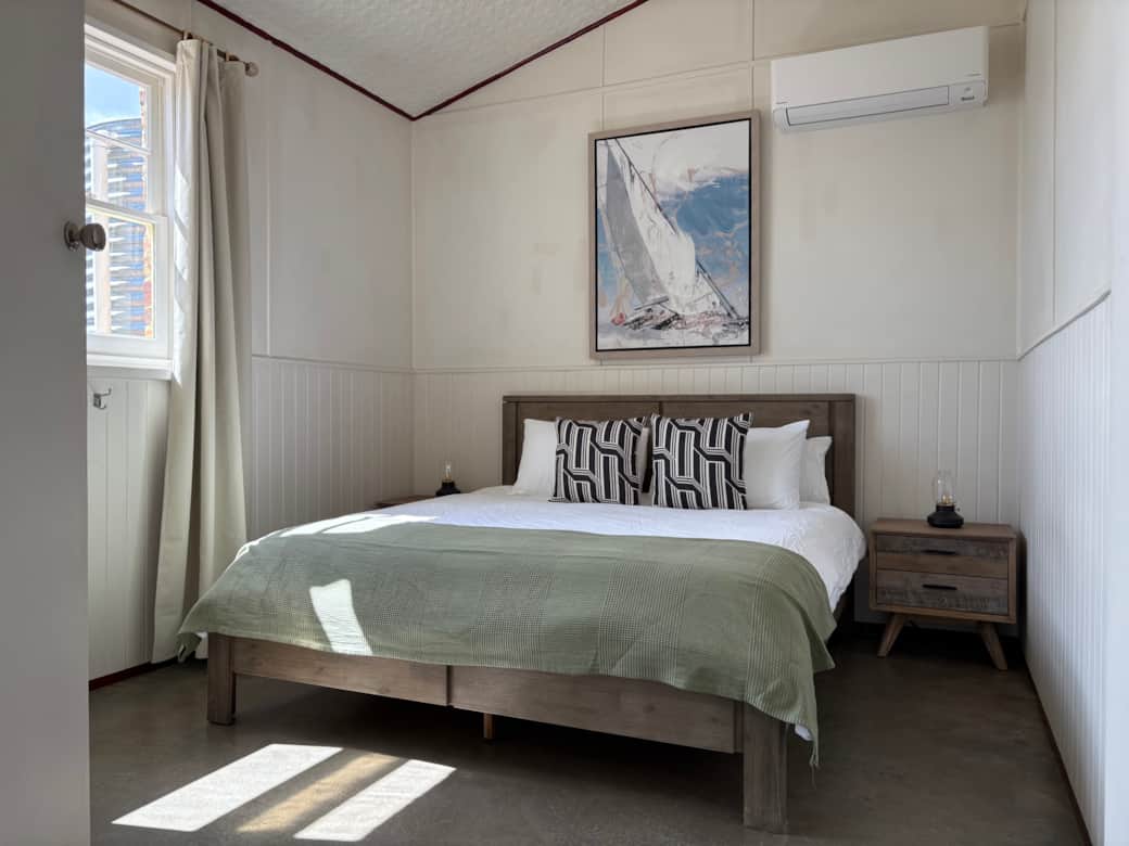 Comfortable downstairs bedroom with air conditioning and spacious wardrobe.