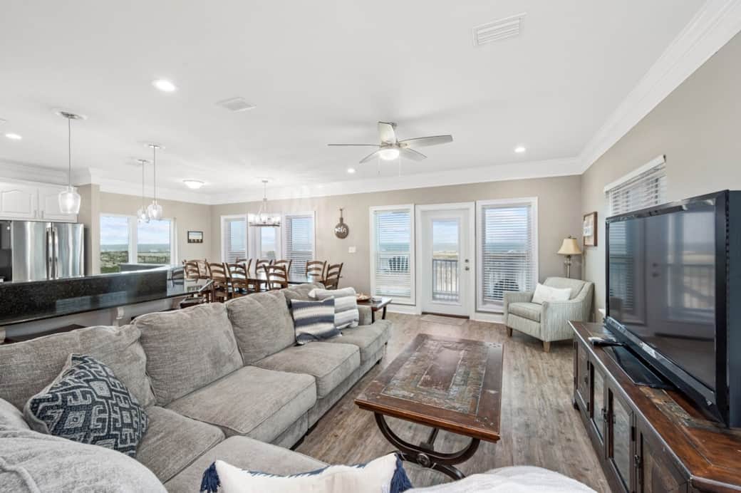 Open concept living room, kitchen, and dinning room.  There is a balcony that overlooks the ocean.  We have recently added shiplap on the wall to protect the walls better.  