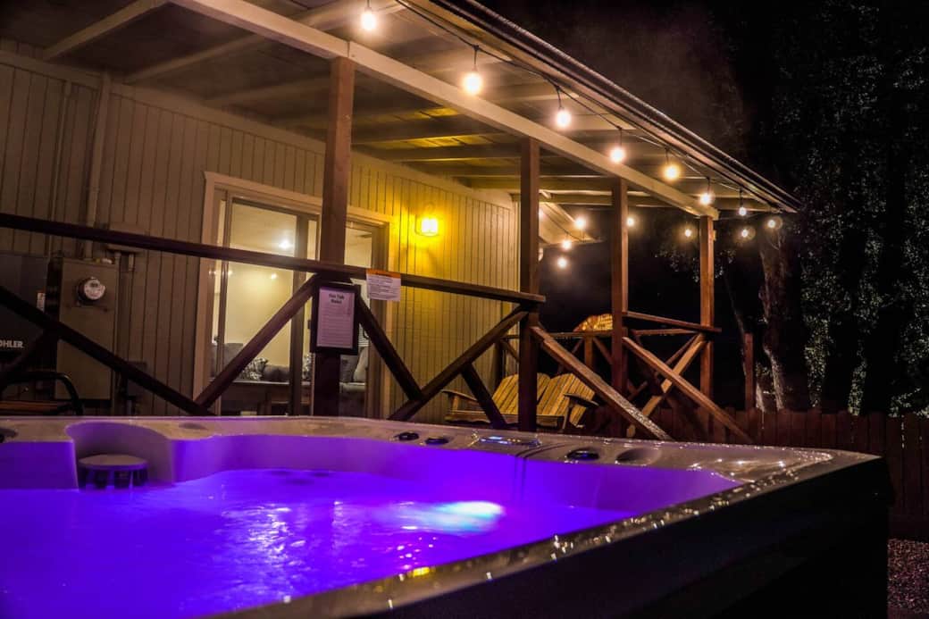 Enjoy the hot tub with a relaxing evening ambiance surrounded by nature and classy string lights.
