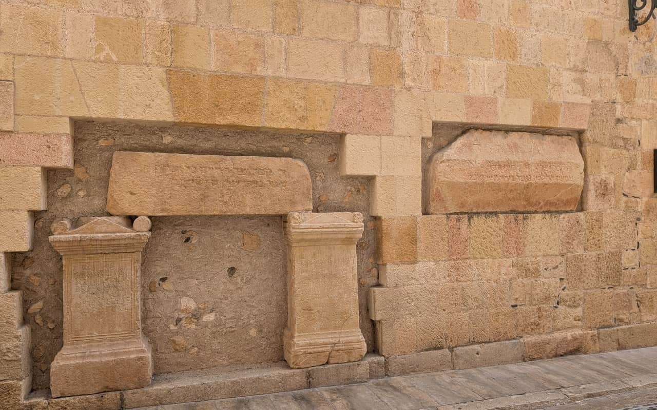 Roman and medieval Jewish stone pieces set into the façade of Casa del Degà in Tarragona