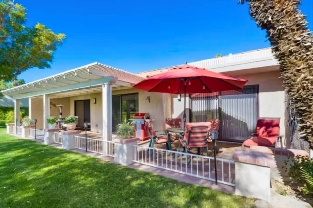 Large Patio with Umbrella Table, Grill, More Seating Options, and a Heater.
