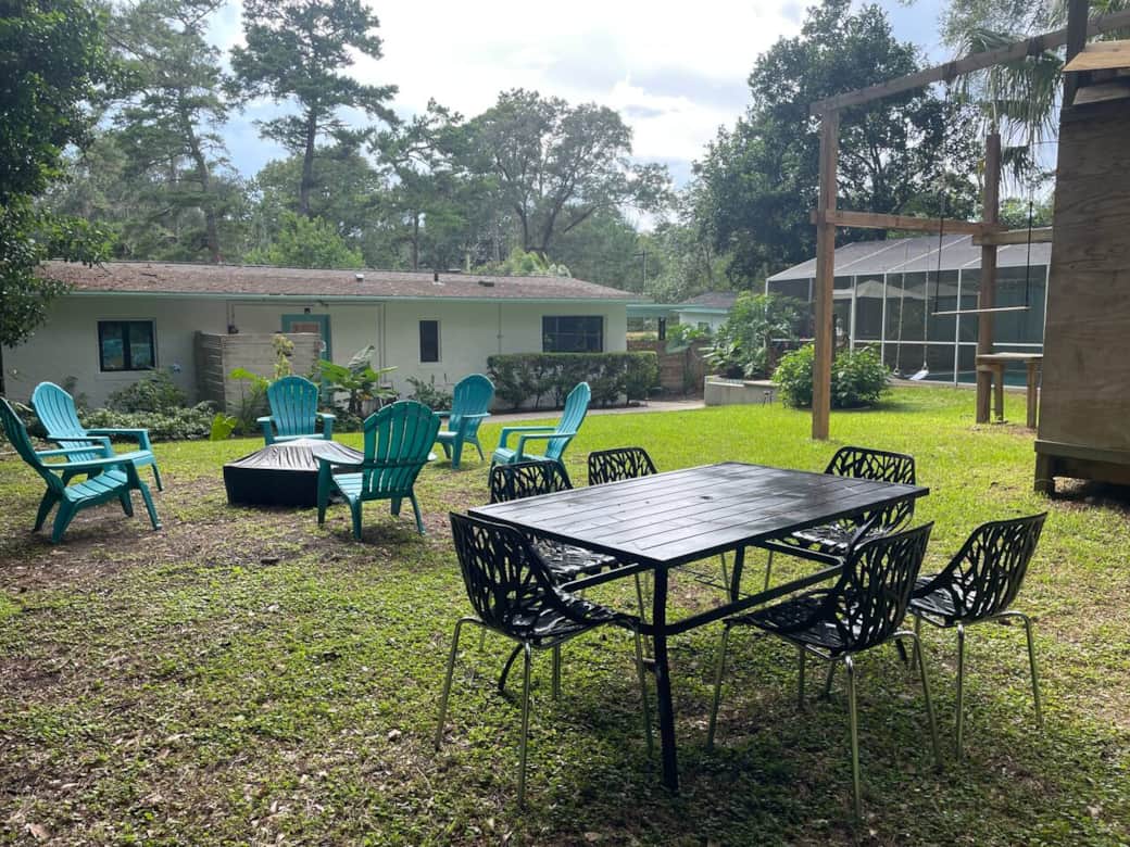 Metal table with 6 chairs for dining and gathering al fresco.
