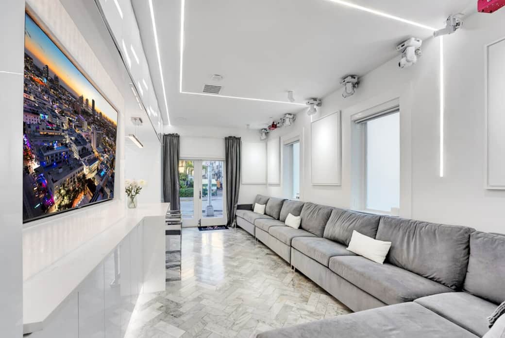 1st FLOOR: LIVING ROOM / PARTY LOUNGE features sectional sofa. TV with surround sound. Sound active nightclub quality lights and lasers mounted on ceiling (shown on right). Bar seating for 2 shown on left. Disco ball reveals from upper cabinets. 1st FLOOR: LIVING ROOM / PARTY LOUNGE features sectional sofa. TV with surround sound. Sound active nightclub quality lights and lasers mounted on ceiling (shown on right). Bar seating for 2 shown on left. Disco ball reveals from upper cabinets.