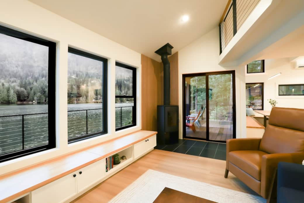 The fireplace in the corner and the sliding glass door to the deck.