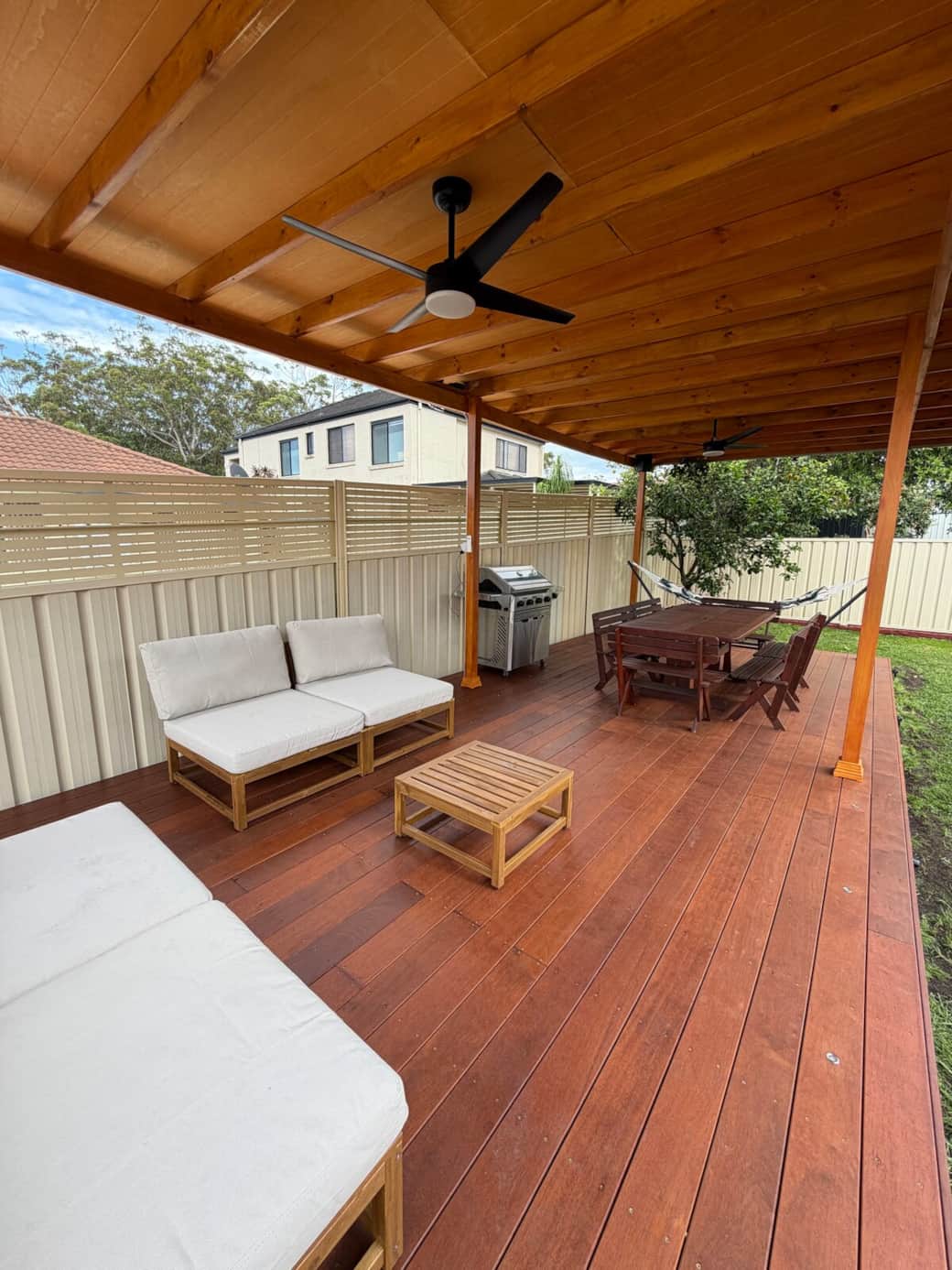 Relax and unwind on the incredible outdoor deck and pergola, equipped with a lounge, dining table, hammock, fans, and music-ready sound system.