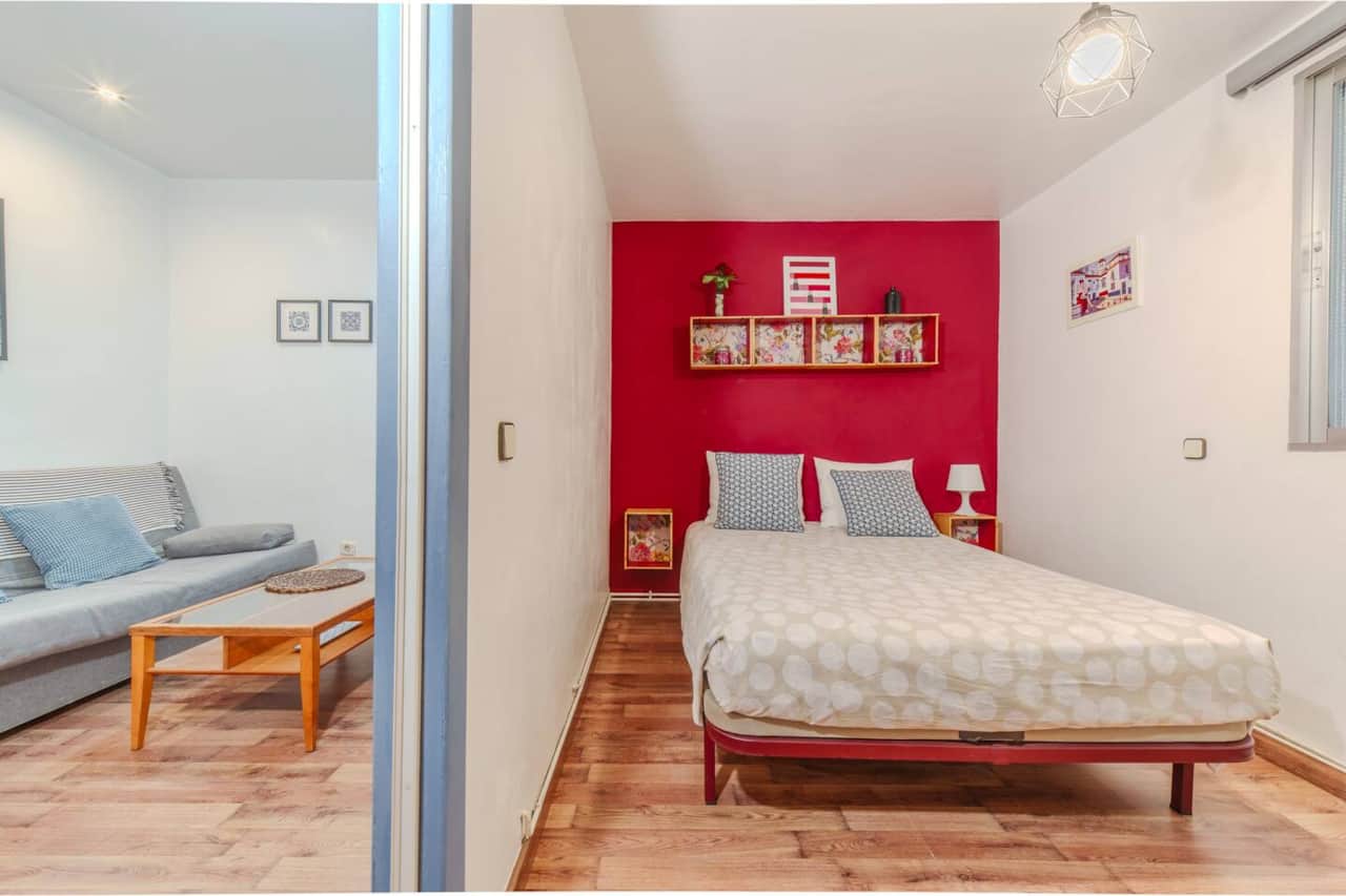 Dormitorio con cama doble y pared granate