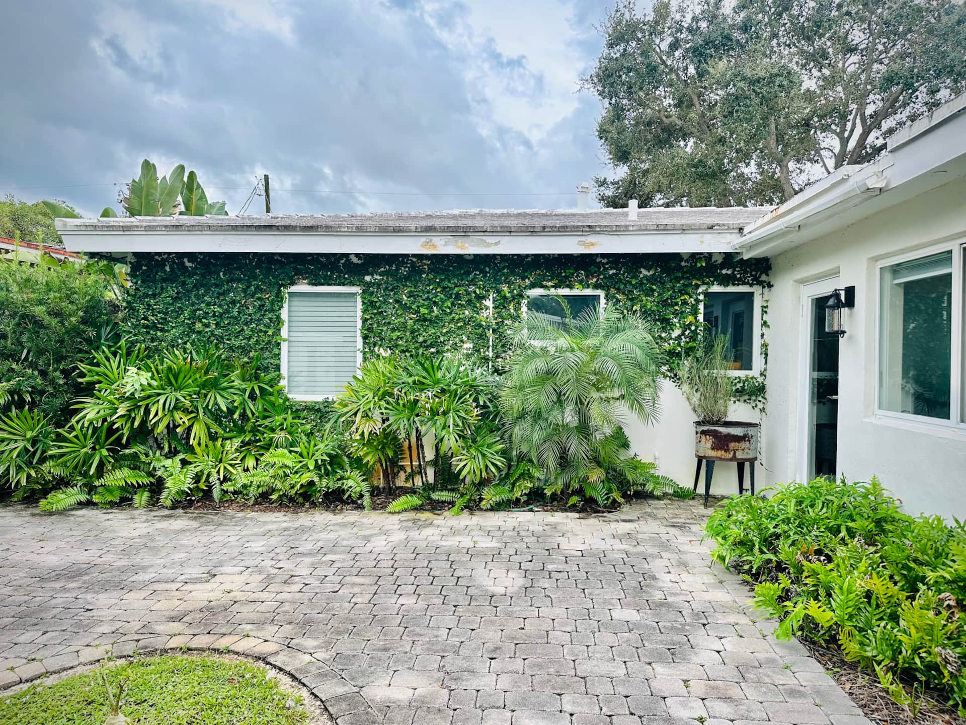 Lush tropical courtyard at Casa Citron framing the private entrance to Unit 3 after renovation