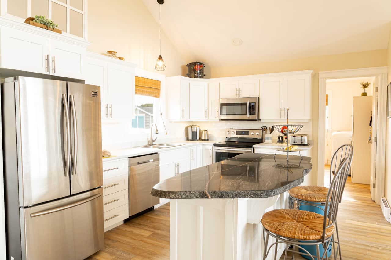 Modern kitchen with stainless steel appliances and granite island