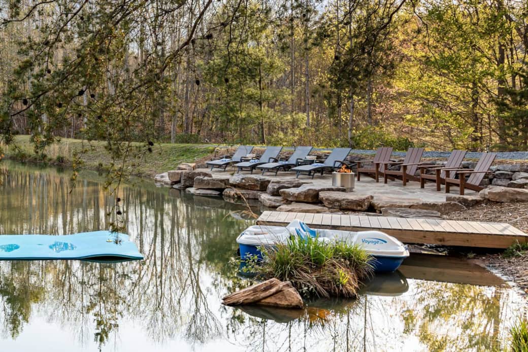 Private stocked mountain lake, swim dock, paddle boards and Adirondack chairs at River Rock Reserve
