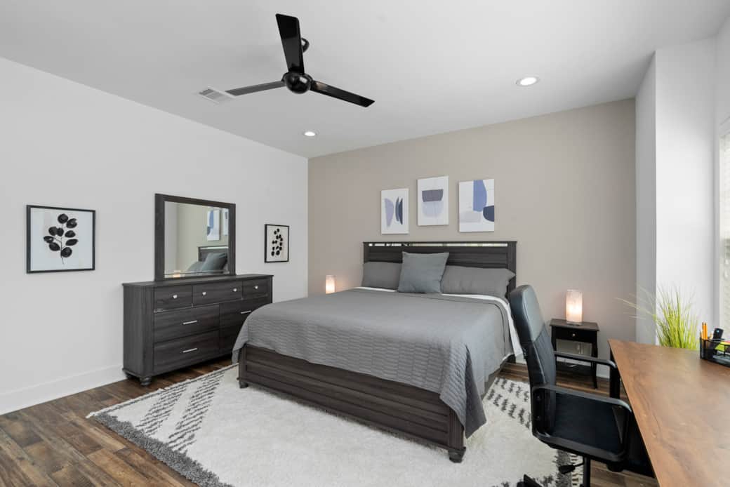 A full dresser and mirror is provide in the primary bedroom to facilitate long-term stays. A full dresser and mirror is provide in the primary bedroom to facilitate long-term stays.