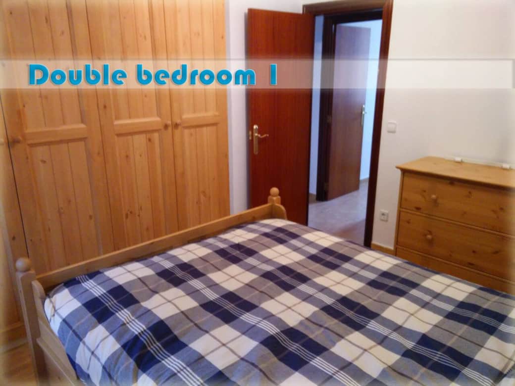 Primary bedroom on the lower floor with a double bed and its own AIRCON and SMART TV.